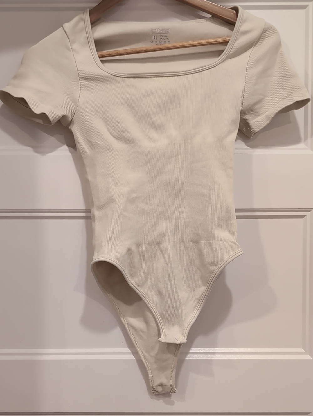 Two OQQ Cream Ribbed Bodysuits